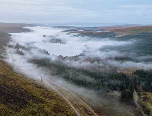 Brecon Beacons lakes under low cloud and mist at dawn.